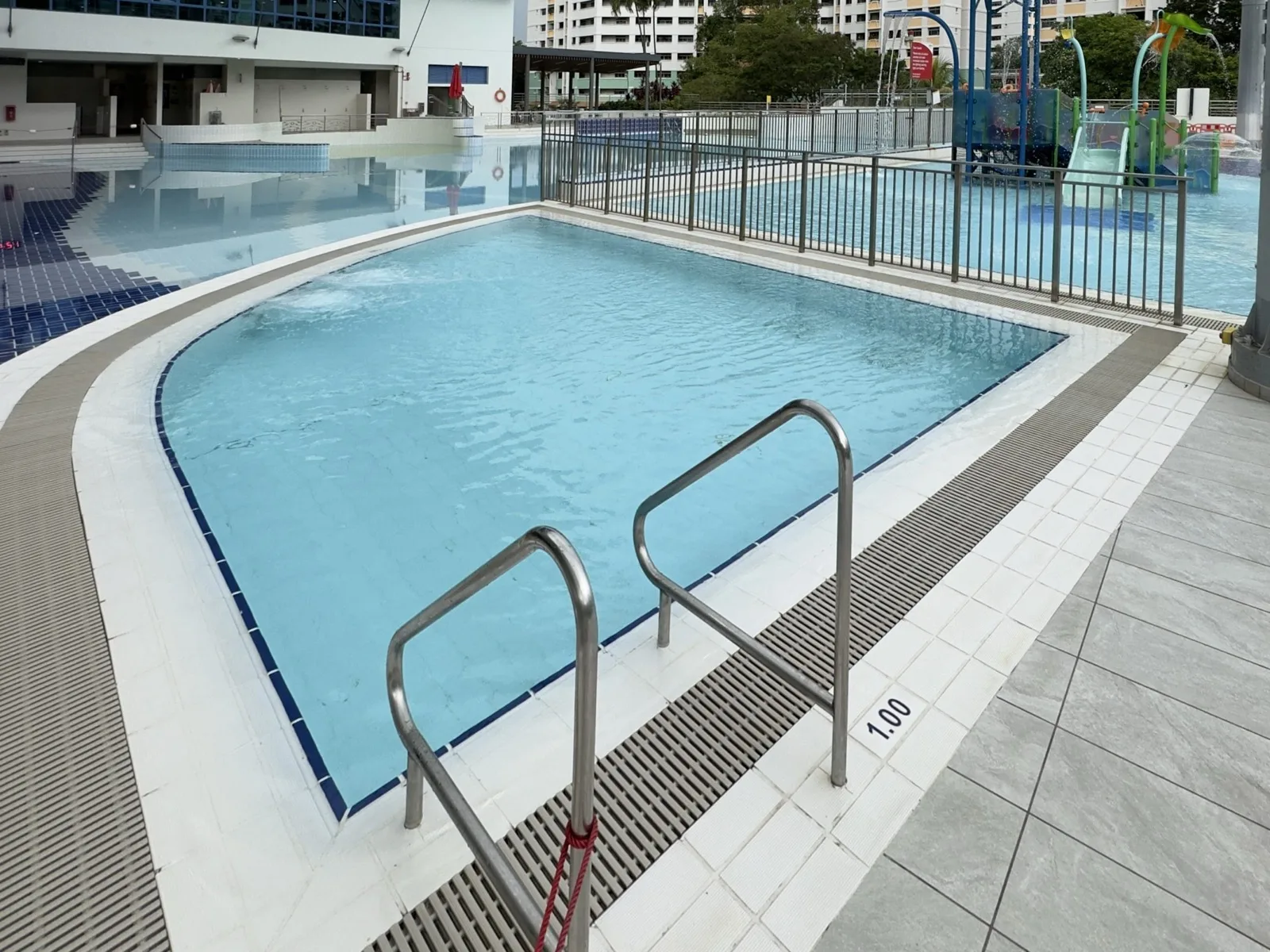 Wave pool with families enjoying the waves at Choa Chu Kang Swimming Complex